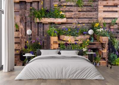 Image of wooden wall with wood boxes full of beautiful colorful flowers. decoration Wall mural