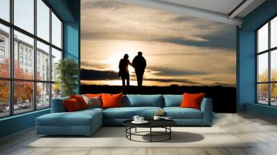 silhouette of elderly couple walking on hill Wall mural