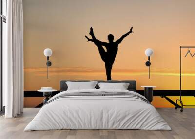 silhouette of female gymnast on balance beam in sunset Wall mural