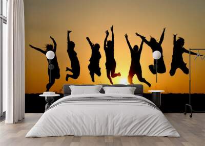 silhouette of friends jumping in sunset Wall mural