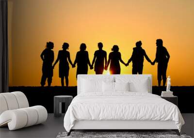 silhouette of group of friends standing in sunset at beach Wall mural