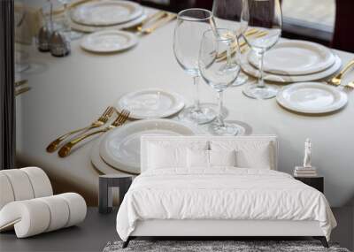 Chic and elegant, gold-plated cutlery and white plates, table setting with empty plates. Wall mural