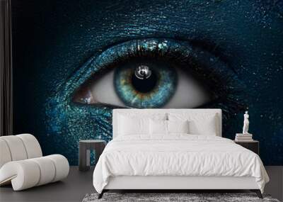 Macro and close-up creative make-up theme: beautiful female eyes with black skin with a blue-green pigment sparkles Wall mural