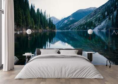 Majestic blue mountain lake with green trees Wall mural