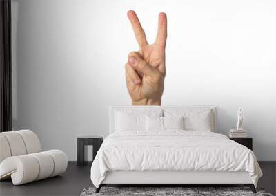 Male hand raised up and showing a gesture of peace with two lifted fingers on a white background. Gesture Yo. Concept of power, unity, rap respect Wall mural