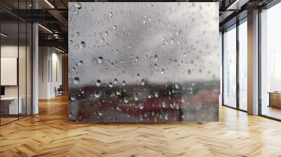 Raindrops on the window against the backdrop of the city out of focus Wall mural