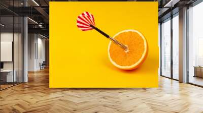 orange slice, fruit with circular target marked and dart on yellow background. minimal idea food and fruit concept. Idea creative to produce work and advertising marketing communications Wall mural