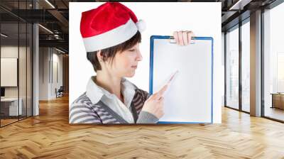 Smiling woman in Santa hat showing on whiteboard by pen Wall mural