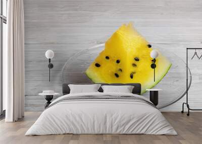 piece of yellow watermelon on a white table background. Wall mural