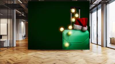 Plastic suitcase, Santa Claus cap and garland on a dark green background. Concept of travel, business trips, trips to visit friends and relatives on Christmas holidays. New Years journey Wall mural