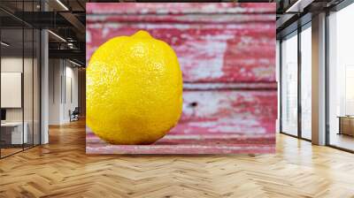 Fresh lemon on aged red wood background Wall mural