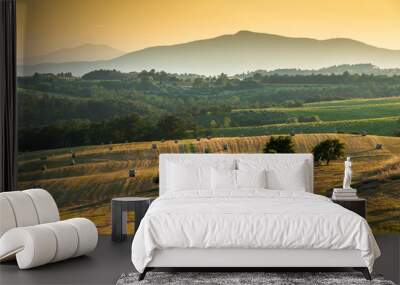 Fresh bales of hay in an Umbrian field at sunset. Wall mural