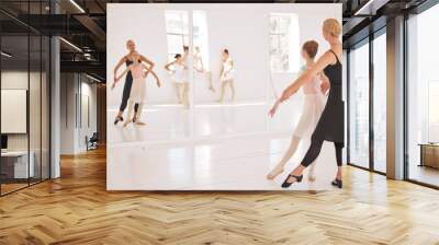 Ballet, student and teacher in dance studio training and motivation support looking in mirror at girl dancer. Creative, school and dancing center with kids learning elegant and artistic Wall mural