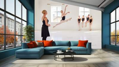 Ballet teacher, dance students and studio with group diversity of ballerina dancers in creative theatre jump performance. Theater room, art or training women in beauty or elegant learning stage class Wall mural