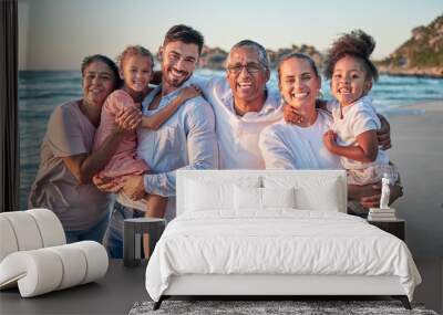 Big family, happy and beach portrait of people with girl children by the sea at sunset. Happiness of a summer vacation with kids spending quality time together on the ocean water waves and sand Wall mural