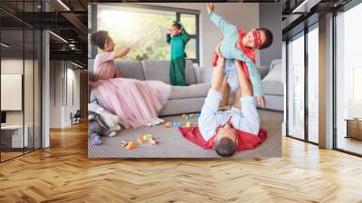 Family, parents and play costume with children for fun bonding and entertainment in home together. Excited, happy and young mother and father enjoy fantasy role play weekend game with kids. Wall mural