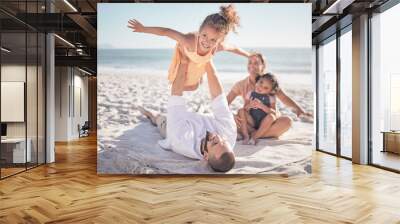 Happy family, travel and beach holiday with children and parents playing in sand together. Love, nature and mother and father bonding with playful girls on an ocean trip, relax outdoor on vacation Wall mural