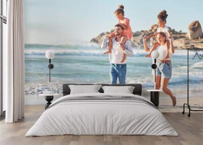 Ocean, piggy back and couple with kids on a summer holiday at the beach. Love, family and fun, man and woman walking with children in sea sand. Vacation, time together and nature, happy in sunshine. Wall mural