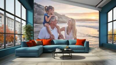 Happy mother, grandfather and kid at beach at sunset on family vacation or summer trip. Ocean, mom and grandparent piggyback girl child for love, connection or support of generations together at sea Wall mural