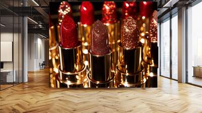 A collection of vibrant red lipsticks glistens in the light, highlighting their rich textures and shimmering finishes. Wall mural