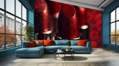 Multiple red lipsticks with a shimmering finish stand prominently against a blurred, glowing background. Rich colors and textures. Soft reflections enhance the luxurious feel of these makeup items Wall mural