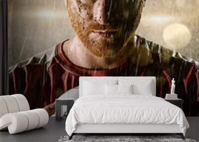 Soccer player on professional soccer night rain stadium. Dirty player in rain drops with football ball Wall mural