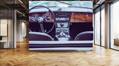 The steering wheel and dashboard of an antique classic car Wall mural