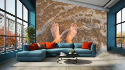 Top view of two man legs into the water Wall mural