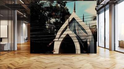 Traditional Thai temple roof with electric wires crossing the scene Wall mural