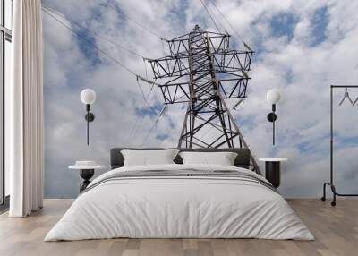 High voltage post.High-voltage tower sky background. High-voltage electrical insulator electric line against the blue sky. Electricity transmission power lines. Wall mural