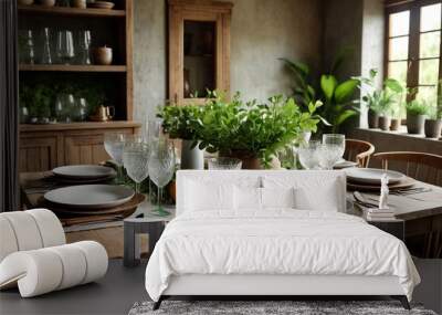 Close up shot of dinner table set up with tableware and glasses in rustic living room at greenery background, indoors. Concept of dining, hospitality and catering. Copy text space for advertising Wall mural