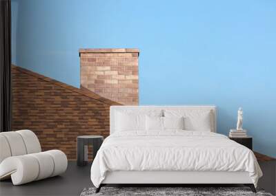 Red brick chimney on shingle roof od new modern house under blue sky on sunny day in summer Wall mural