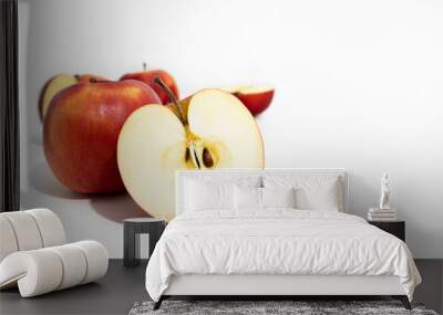 Whole and cut red fresh apples on white background, side view Wall mural