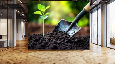 With the first light of day breaking, a gardener cultivates a fresh green seedling, symbolizing hope and growth in nutrient-rich soil Wall mural