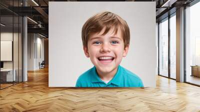 Young happy boy portrait with brown hair smiles broadly, revealing his white teeth, isolated background Wall mural