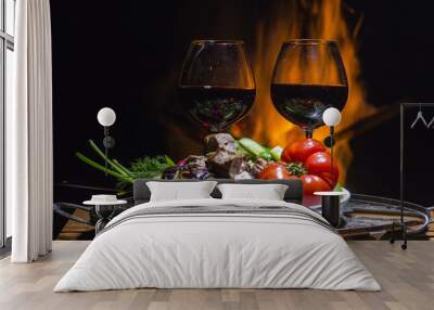 Two glasses of wine with flame on background Wall mural