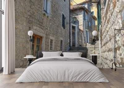 Vertical shot of a narrow street with old buildings. Wall mural