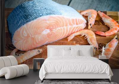 Raw salmon and shrimps on the wooden board Wall mural