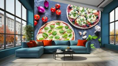 Two pizzas with ingredients on the wooden background Wall mural