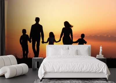 Silhouettes of happy family holding the hands in the meadow during sunset. Wall mural