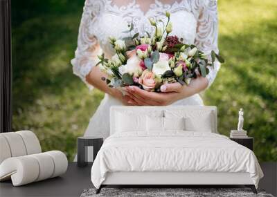 Wedding flowers. Bridal bouquet with exotic flowers. Bride holding a bouquet. wedding details. soft focus Wall mural