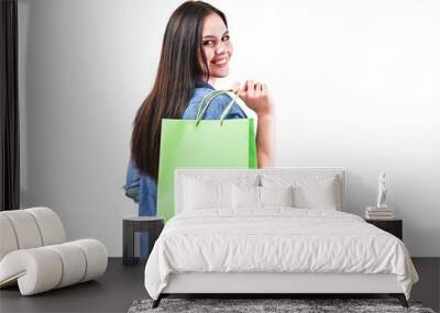 Happy woman with shopping bag on white isolated background. Pretty smiling girl in studio. Sale Wall mural