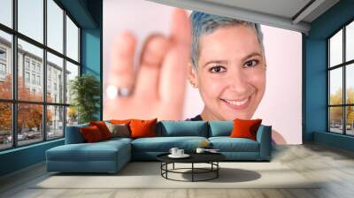 Joyful happy woman. Portrait of brazilian hipster girl with blue hair and beautiful smile in studio. 30 year old cute person on isolated background Wall mural