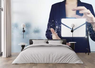 Email and sms marketing concept. Two hand holding virtual holographic Email and sms icon with light blurred background. Email marketing concept. Sending newsletter Wall mural