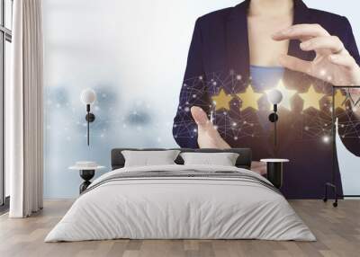 Review, Rating,Satisfaction. Two hand holding virtual holographic five stars icon with light blurred background. Customer Experience Concept. Wall mural