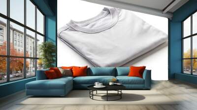 A white shirt is folded and laying on a white background Wall mural