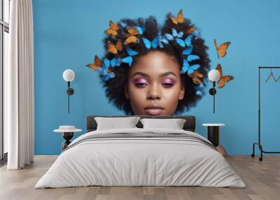 A woman adorned with butterflies in her hair is depicted in front of a vibrant blue background, showcasing elements of nature and beauty Wall mural