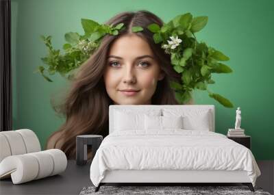 A woman with a leaf and flower wreath smiling in nature for a flash photo Wall mural