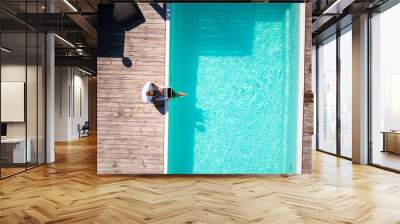 top view of well dressed male sitting at the pool with laprop and working Wall mural