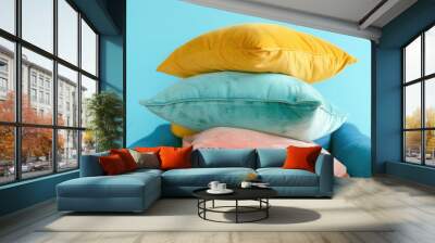 A person is holding up a stack of pillows, creative way to display pillows Wall mural